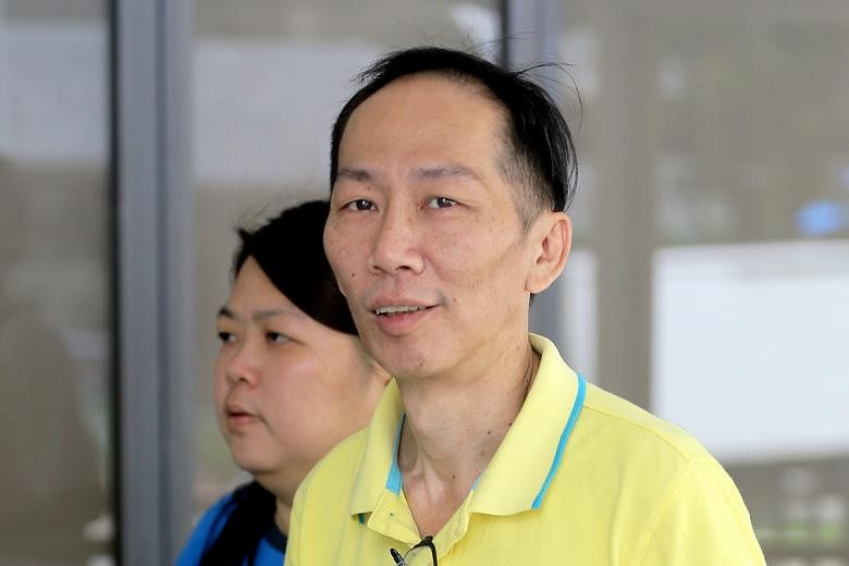Chin Peng Sum arriving at the State Courts with his wife yesterday. Chin, who has been with the ICA since February 1998, has been suspended from service since June 2017.
