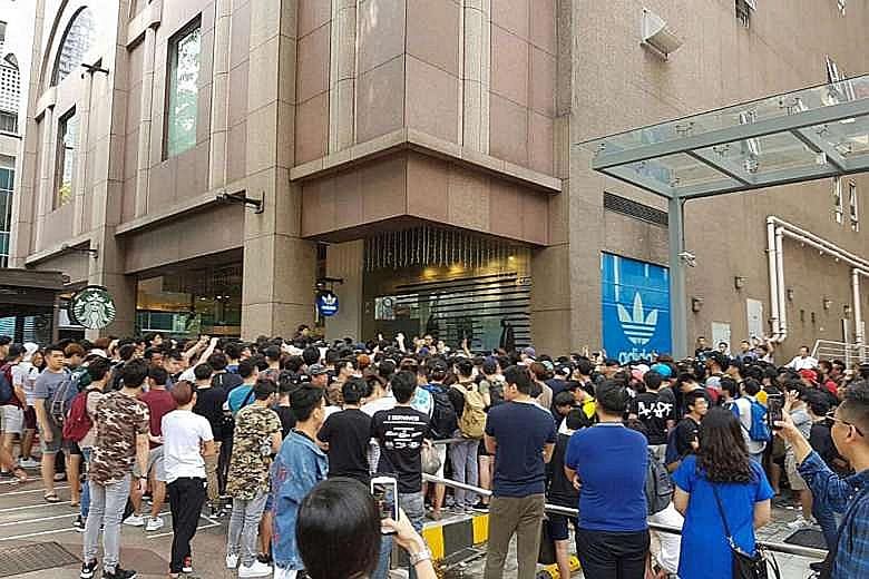A crowd outside the adidas Originals store at Pacific Plaza. The evolution of business models to focus on athleisure - a combination of "athletics" and "leisure" - has fuelled a sector dominated by giants like Nike and adidas.