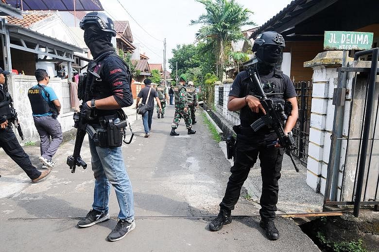 The Indonesian police's anti-terror unit Detachment 88 conducting a raid in Tangerang last May. A new anti-terror law passed last year allows police to make pre-emptive arrests, among other things.