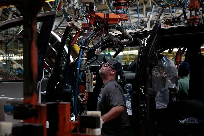 An assembly line at a Ford Motor Company complex in Michigan. The probability of a US recession over the next 12 months is 30 per cent, say some analysts. Others note that the US economy accelerated last year, boosted by robust consumption and a pick
