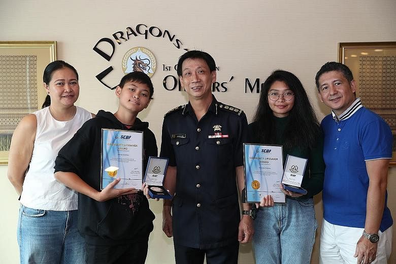 Colonel Lim Boon Hwee, Commander of the 1st SCDF Division, with (from left) Mrs Laureen Cordova, her son Joshua, daughter Mikkaela, and husband Jun. With the help of her brother, Miss Cordova pulled out an unconscious boy from the 2.4m-deep pool at M