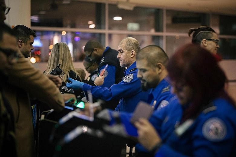 US Transportation Security Administration (TSA) agents continuing their work at Chicago's Midway International Airport on Dec 22, despite the partial government shutdown, which has affected an array of American federal institutions and services.