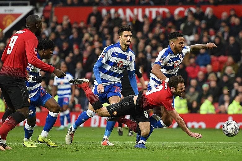 Juan Mata being fouled against Reading in the FA Cup third round at Old Trafford. He scored United's opener from the spot kick given by the video assistant referee.