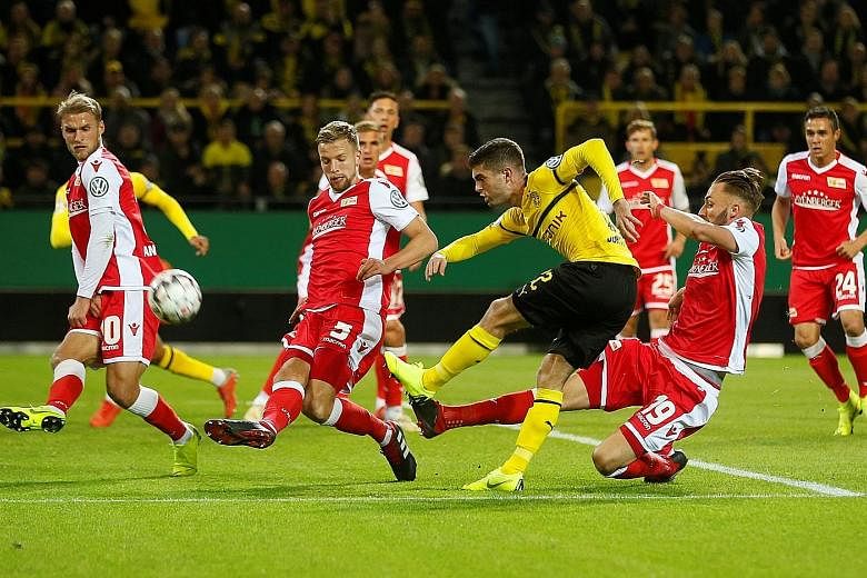 Christian Pulisic taking a shot for Borussia Dortmund in a match back in October. His £58 million (S$100 million) transfer to Premier League side Chelsea at the opening of the January window on Wednesday is set to be the exception among top clubs.