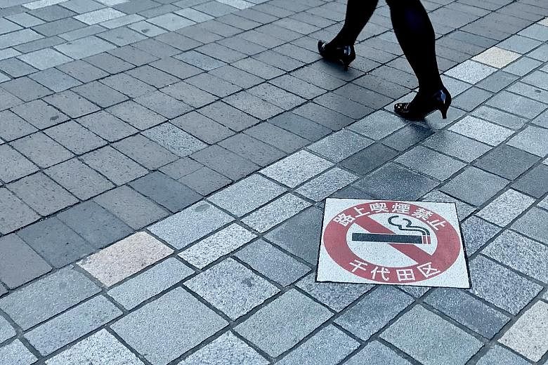 A "No Smoking On The Streets" sign in Tokyo's Chiyoda ward, the first of the Japanese capital's 23 wards to outlaw public smoking in 2002, with offenders facing fines of 2,000 yen (S$25).