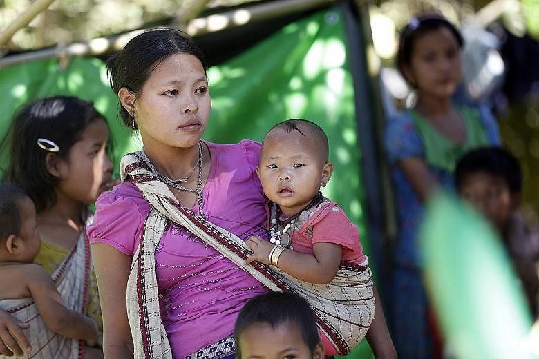Ethnic Rakhine people, who fled from an area of conflict, at a temporary camp in Kyauk Taw township, in northern Rakhine state, yesterday.