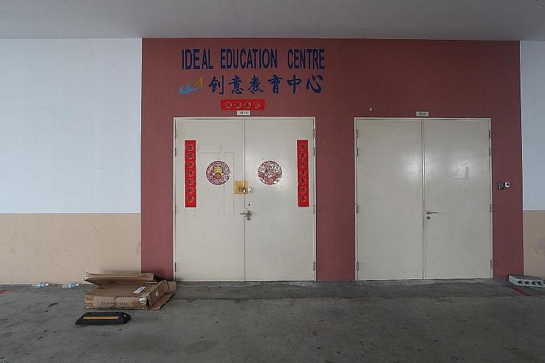 Above: The education centre where Soo Jia He was accidentally locked inside. He had been left alone for around 10 minutes, say his parents, who rushed back to their office to find their son lying at the foot of the building. Left: Prayers being perfo