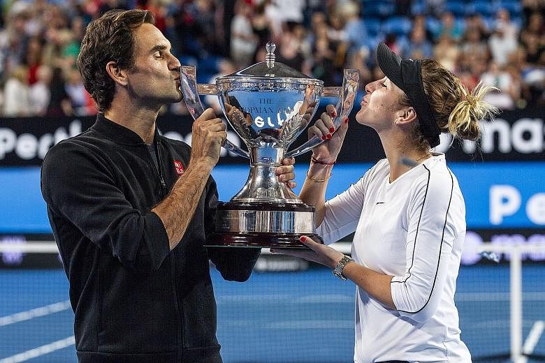 Switzerland's Roger Federer and mixed doubles partner Belinda Bencic after winning the Hopman Cup in Perth on Saturday. With tie-break rules in place, marathon final sets will be missed, says Federer.