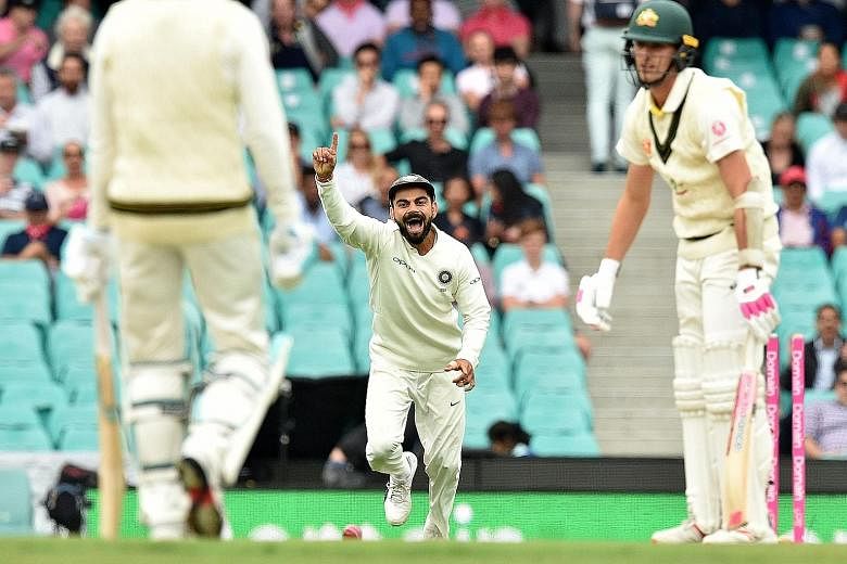 India captain Virat Kohli celebrating after Australia batsman Pat Cummins was clean bowled by Mohammed Shami on the fourth day of the fourth and final cricket Test between Australia and India at the Sydney Cricket Ground.