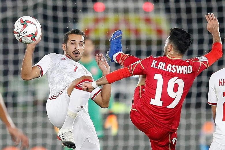 The UAE's Ali Mabkhout (far left) challenging Bahrain's Kamail Al Aswad for the ball during the teams' 1-1 draw in the Asian Cup Group A match on Saturday.