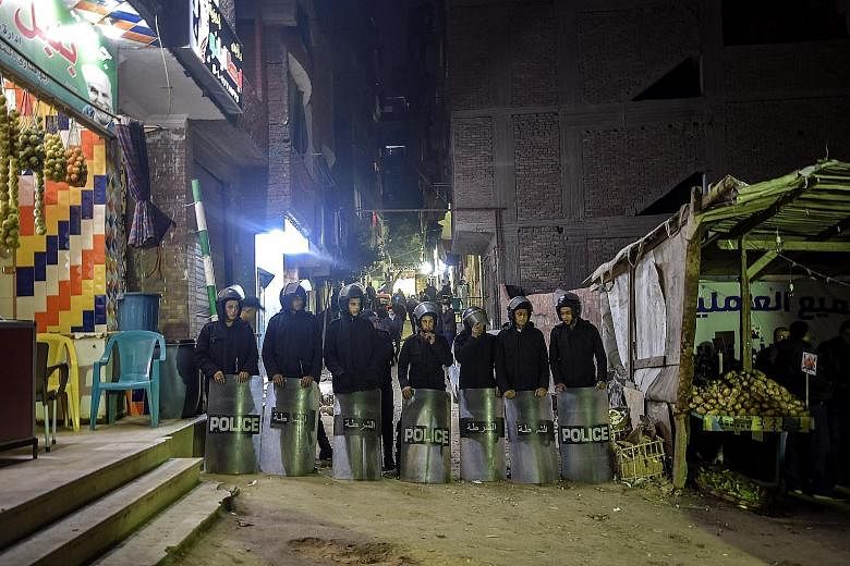Police officers guarding the street leading to the church in Cairo where the bomb was found last Saturday.