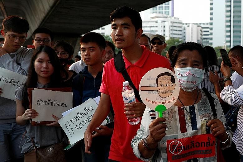 Activists protesting in Bangkok yesterday against a possible delay of an election set to be held on Feb 24, following the lifting of a ban on political activity imposed after a 2014 coup.
