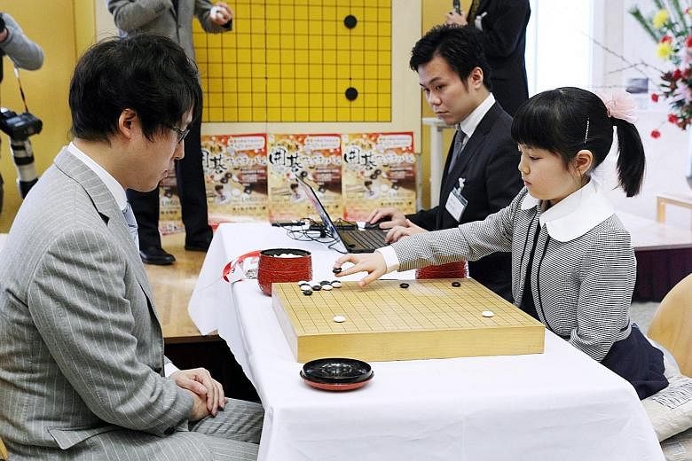Sumire Nakamura playing against Mr Yuta Iyama in Osaka on Sunday. Sumire started playing Go with her father, national champion Shinya Nakamura, when she was three.