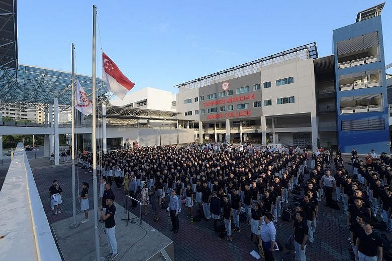 The TMJC flag and state flag being raised. Students will get to shape the college's new culture, with the school song yet to be written. Tampines Meridian Junior College students watching as the old flags of Tampines JC and Meridian JC were lowered o
