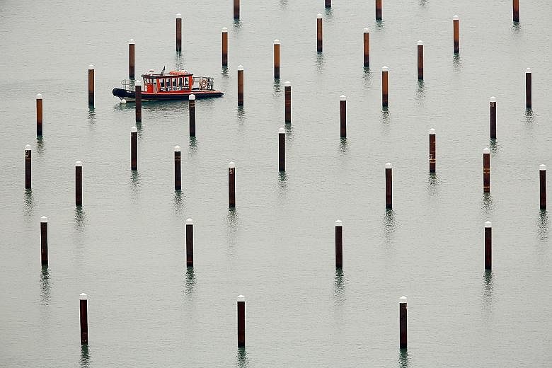 A safety craft manoeuvring its way among pilings at Dover Marina in Britain last Saturday. The port, which operates 120 ferries a day carrying 10,000 lorries, accounts for 17 per cent of Britain's trade in goods. As part of a government exercise yest