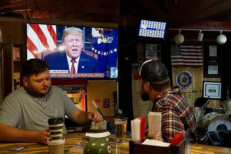 (Left) Customers at a California bar watching Mr Trump's first Oval Office address to the nation on Tuesday.
