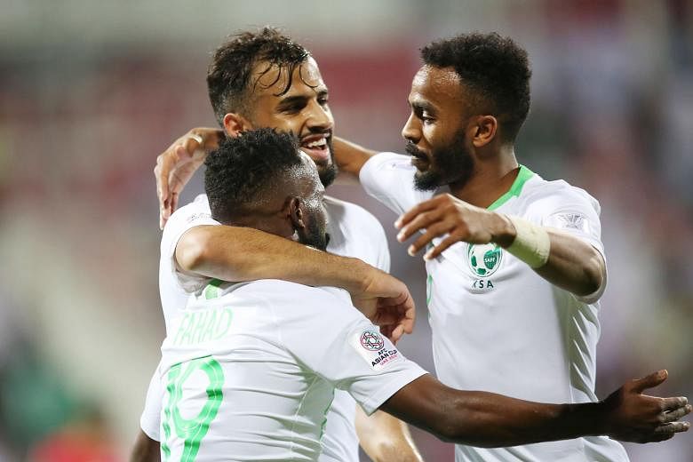 Saudi Arabia players celebrating one of their four goals. They got their Asian Cup campaign rolling with a 4-0 win over North Korea.