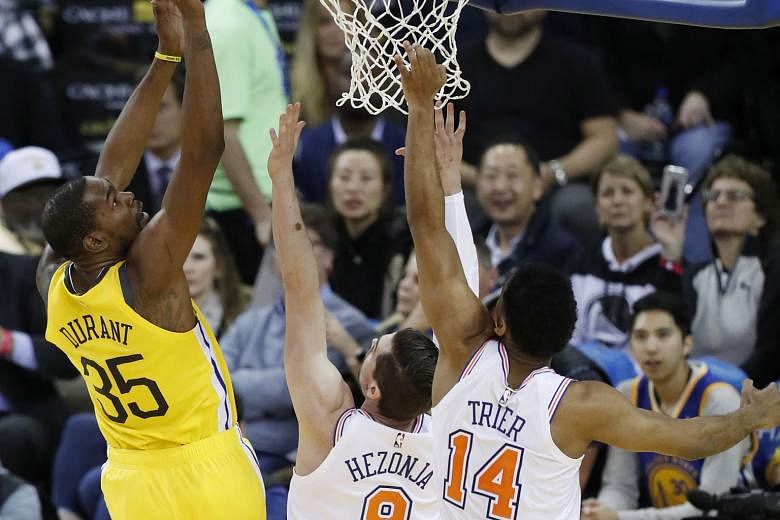 Forward Kevin Durant taking a shot en route to scoring 24 points for the Golden State Warriors at the Oracle Arena on Tuesday. The 122-95 win over the New York Knicks halted the Warriors' three-game home losing run.