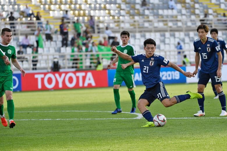 Japan's Ritsu Doan shaping to shoot before scoring his team's third goal in their 3-2 Asian Cup Group F win over Turkmenistan yesterday. The Samurai Blue scored their goals in a 15-minute second-half spell to erase a 1-0 half-time deficit.