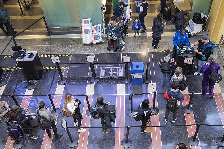 A Transportation Security Administration agent checking travellers' identification at Ronald Reagan Washington National Airport in Virginia on Monday.