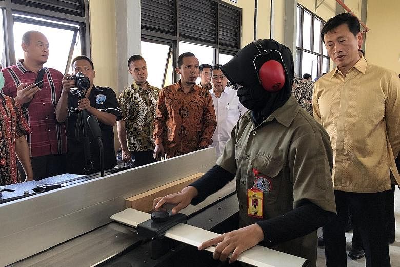 Education Minister Ong Ye Kung touring the workshop at Kendal Furniture and Wood Processing Industry Polytechnic, one of Indonesia's newest polytechnics. Indonesia's Industry Minister Airlangga Hartarto said the government is committed to building mo