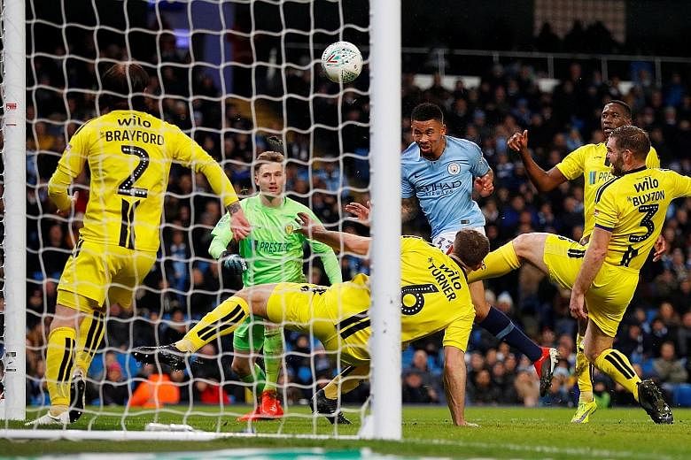 Manchester City's Gabriel Jesus heading home the first of his four goals against Burton in the first leg of their League Cup semi-final. City's nine-goal advantage all but secures their spot in the final.