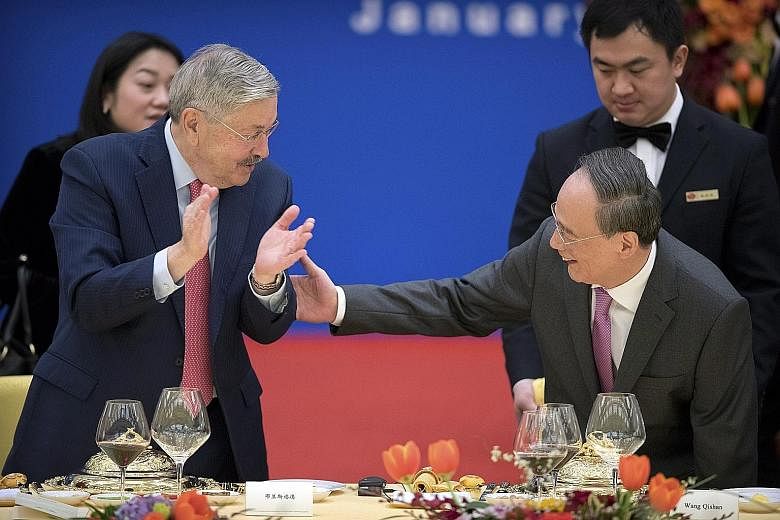 American Ambassador to China Terry Branstad and China's Vice-President Wang Qishan at an event to commemorate the 40th anniversary of the establishment of diplomatic relations between the United States and China, in Beijing yesterday.