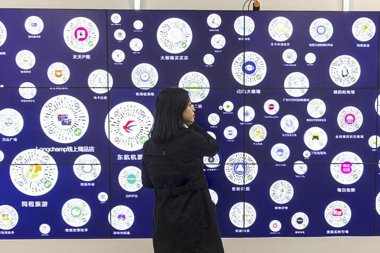A screen displaying QR codes for various programmes and services at Tencent's WeChat Open Class Pro conference in Guangzhou last year. WeChat is the fifth-most popular network globally, and countries including Australia and India have blocked the use