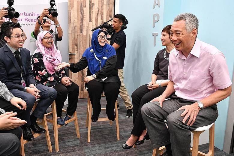 (From far right) Prime Minister Lee Hsien Loong and Manpower Minister Josephine Teo chatting with career coach Noralizah Aziz, assistant staff nurse Suriana Sarip and her employer, Dr Ng Yew Yee. Ms Suriana was an administrative assistant who took a 