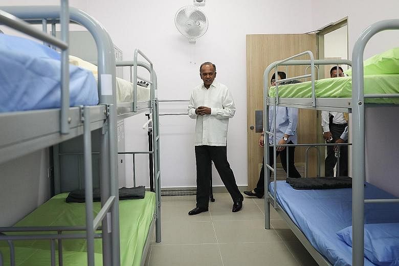 Home Affairs and Law Minister K. Shanmugam touring the women's block of Selarang Halfway House yesterday. The halfway house, Singapore's first such institution to be run by the Government, aims to improve the rehabilitation and reintegration of offen