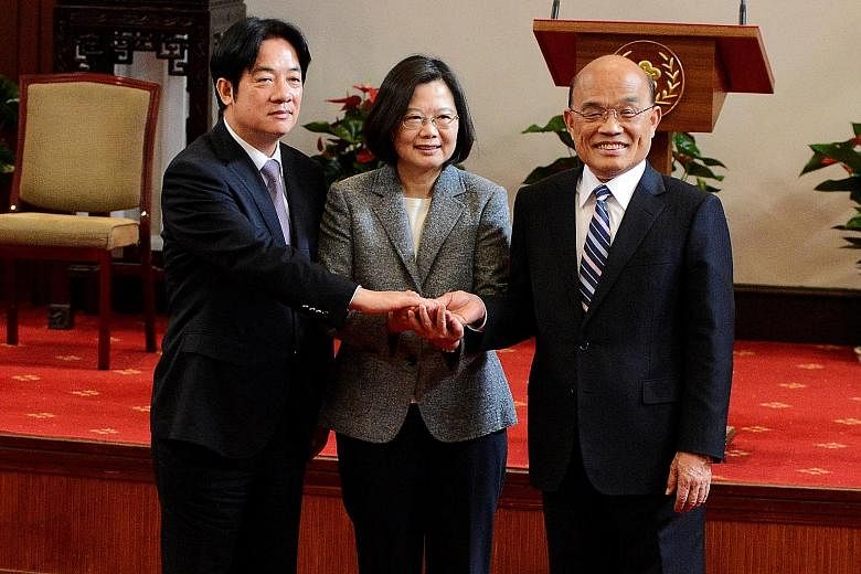 Taiwan President Tsai Ing-wen flanked by former premier William Lai (far left) and new premier Su Tseng-chang after a news conference in Taipei yesterday. The new administration will be tasked with winning back public support after the Democratic Pro