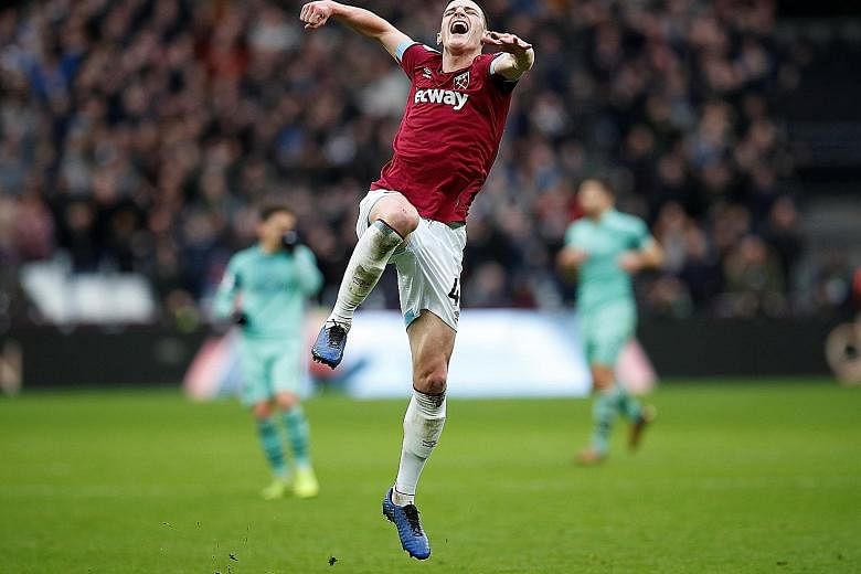 West Ham United's Declan Rice, who turns 20 tomorrow, jumps for joy after the final whistle at the London Stadium yesterday. His 48th-minute goal earned the Hammers a thoroughly deserved 1-0 win over the Gunners. It was West Ham's first home victory 