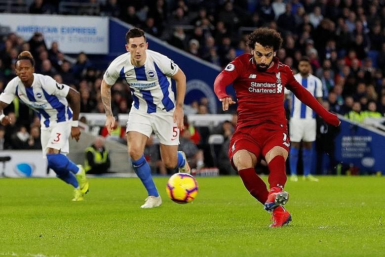 Mohamed Salah putting away the 50th-minute penalty he earned at Brighton yesterday after being hacked down by midfielder Pascal Gross. It earned the Premier League leaders their first win this year, after setbacks at champions Manchester City in the 
