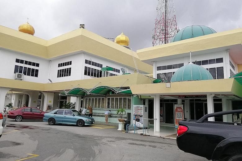 TOP: Sultan Muhammad V attending prayers at Masjid Al Sultan Ismail Petra in Kelantan. He is often seen in a jubah and mingles easily with the people. ABOVE: The Sultan Muhammad II Mosque is a few metres away from Istana Telipot and is frequented by 