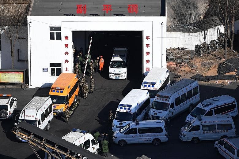 Rescuers at the coal mine owned by Baiji Mining in Shaanxi, China, yesterday. A total of 87 people were working underground when the roof of the mine collapsed on Saturday and 66 were safely evacuated. Rescuers found two remaining miners dead yesterd