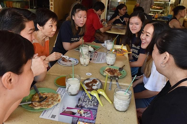 Minister for Culture, Community and Youth Grace Fu having a local breakfast with (from left) Temasek Polytechnic students Vivian Zhu and Keisia Lim-Urquhart, Ngee Ann Polytechnic student Poh Huan Rong and Ngee Ann Polytechnic lecturer Pauline Ooi at 