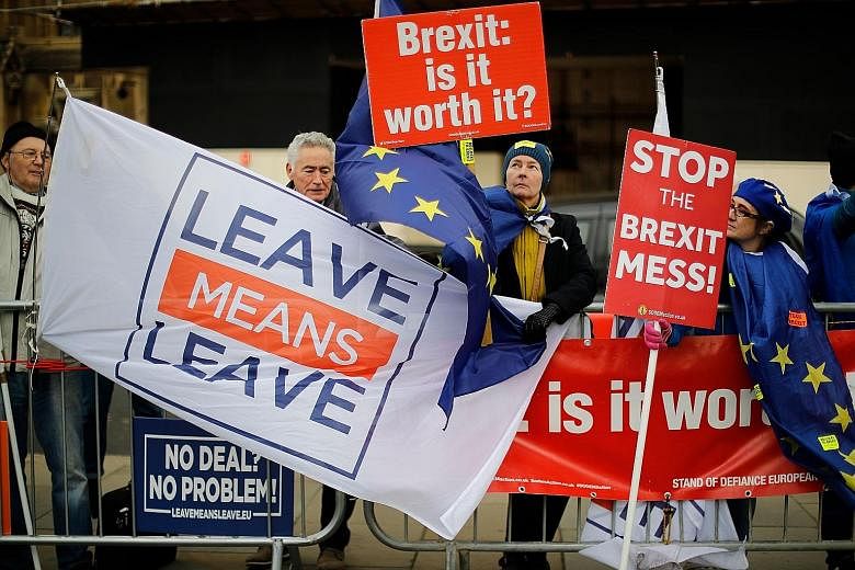 Pro and anti-Brexit supporters demonstrating outside the Houses of Parliament in London yesterday, as Prime Minister Theresa May warned MPs against failing to deliver Brexit.