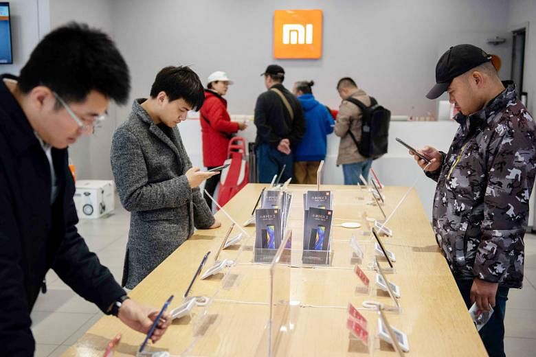 Customers at a Xiaomi shop in Beijing last November. Although Xiaomi started out as a smartphone brand, it is now recognised as a major technology brand with a big presence in consumer electronics, and is riding the wave of shoppers who buy local bra
