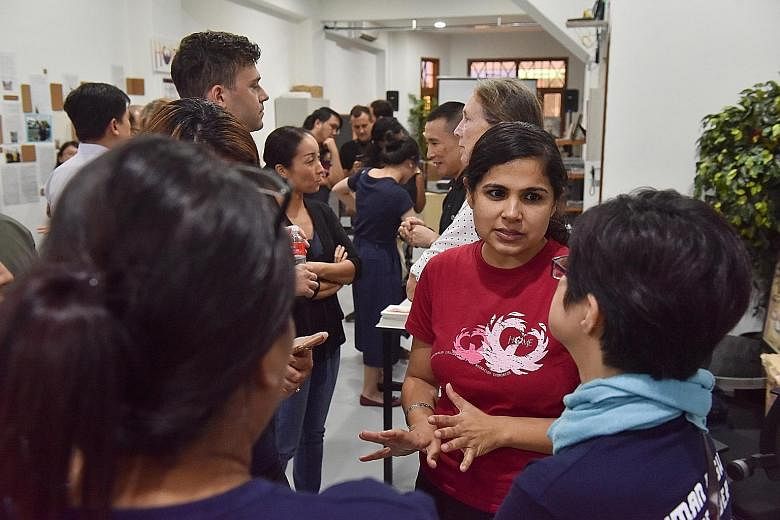 Ms Sheena Kanwar, Home's executive director, talking with participants at an event yesterday to launch the report by the group and Hong Kong-based anti-trafficking group Liberty Shared on forced labour in Singapore's domestic work sector.
