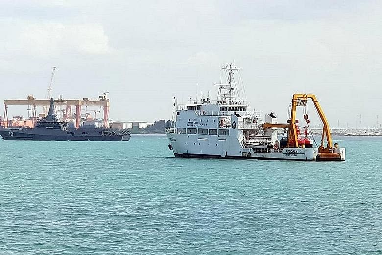 Republic of Singapore Navy's littoral mission vessel RSS Justice (left) near the Malaysian Marine Department vessel Pedoman anchored within Singapore port limits. The Republic's security agencies have been ordered to avoid escalating tensions for now
