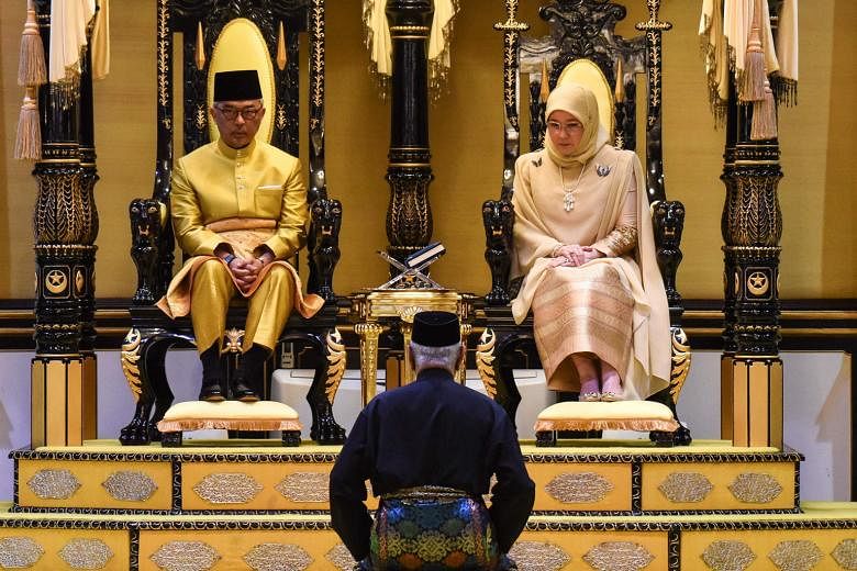 Sultan Abdullah Ibni Sultan Ahmad Shah and his consort Tunku Azizah Aminah Maimunah Iskandariah seated on their thrones during their coronation at the Istana Abu Bakar in Pekan, Pahang, yesterday.
