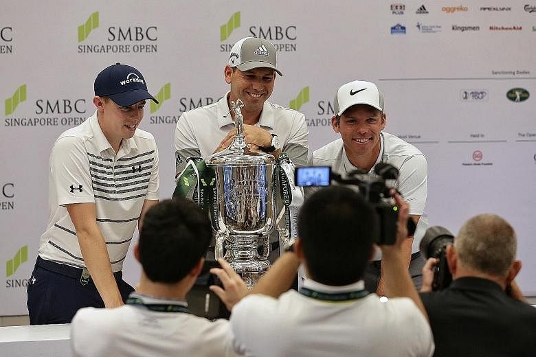 Defending champion Sergio Garcia, flanked by Englishmen Matthew Fitzpatrick (far left) and Paul Casey, playfully showing his reluctance to hand back the trophy during Tuesday's press conference. The home contingent for the SMBC Singapore Open at the 