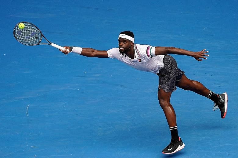 American Frances Tiafoe stretching for a return in his upset win over fifth seed Kevin Anderson of South Africa in the second round of the Australian Open in Melbourne yesterday.