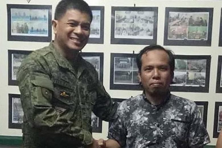 Brigadier-General Ariel Felicidario, acting commander of Joint Task Force Basilan, with Indonesian Samsul Saguni, who was rescued on Tuesday. Mr Samsul was kidnapped on Sept 11 by Abu Sayyaf from a Malaysian fishing boat near Semporna, Sabah.