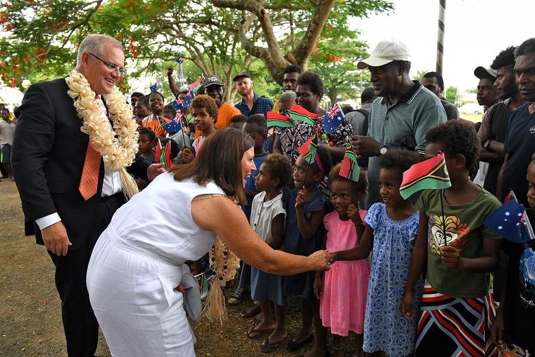 Australian Prime Minister Scott Morrison and his wife, Mrs Jenny Morrison, being welcomed to the National Archives and Library in Port Vila, Vanuatu, by residents yesterday.
