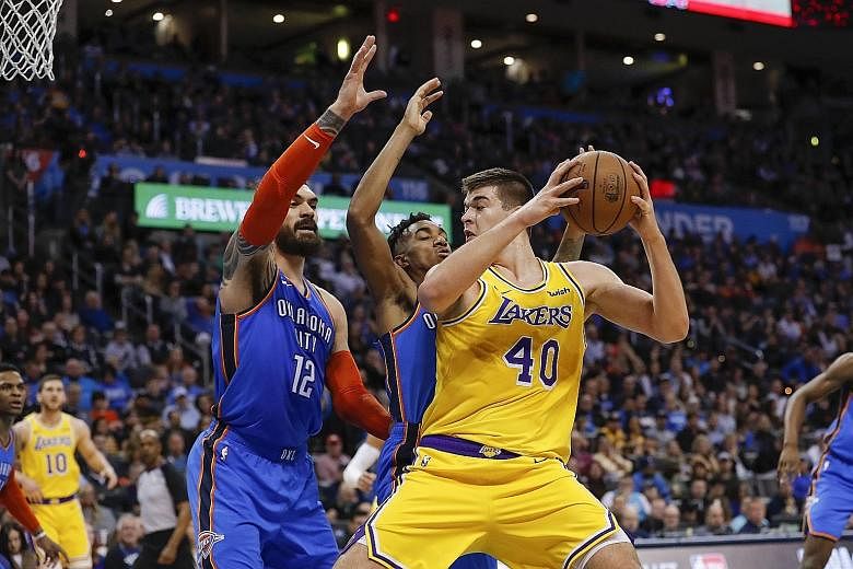 Los Angeles Lakers centre Ivica Zubac, who scored a career-high 26 points, tries to get past centre Steven Adams (12) and guard Terrance Ferguson of the Oklahoma City Thunder in the 138-128 overtime win on Thursday. The Lakers, paced by Kyle Kuzma's 