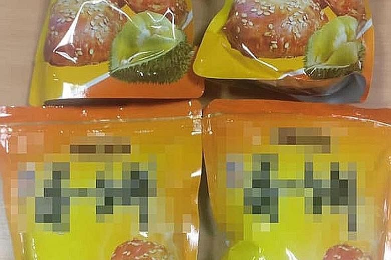 ICA officers caught two Singaporeans who tried to bring in bak kwa from Malaysia by hiding the meat product in packets of durian-flavoured biscuits.