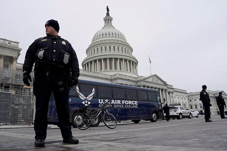A US Air Force bus meant to transport House Speaker Nancy Pelosi and others to a flight to Belgium and Afghanistan parked outside the Capitol on Thursday after President Donald Trump cancelled the flight as his dispute with congressional Democrats ov