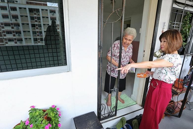Dr Amy Khor visiting residents at Jurong West Street 73 to share dengue prevention tips yesterday.
