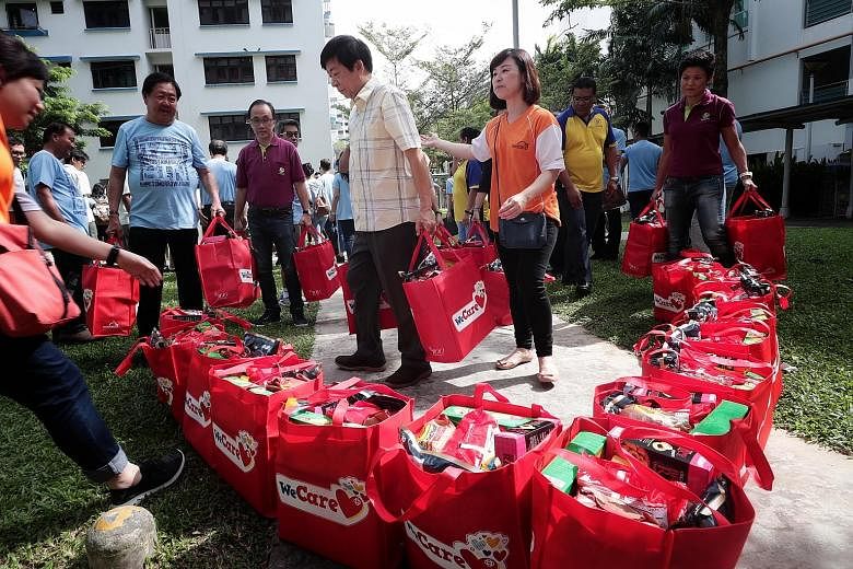 More than 450 low-income households in Sembawang received red festive bags yesterday containing groceries, such as coffee powder, oatmeal and biscuits, as part of an annual charity effort led by the North West Community Development Council. The three